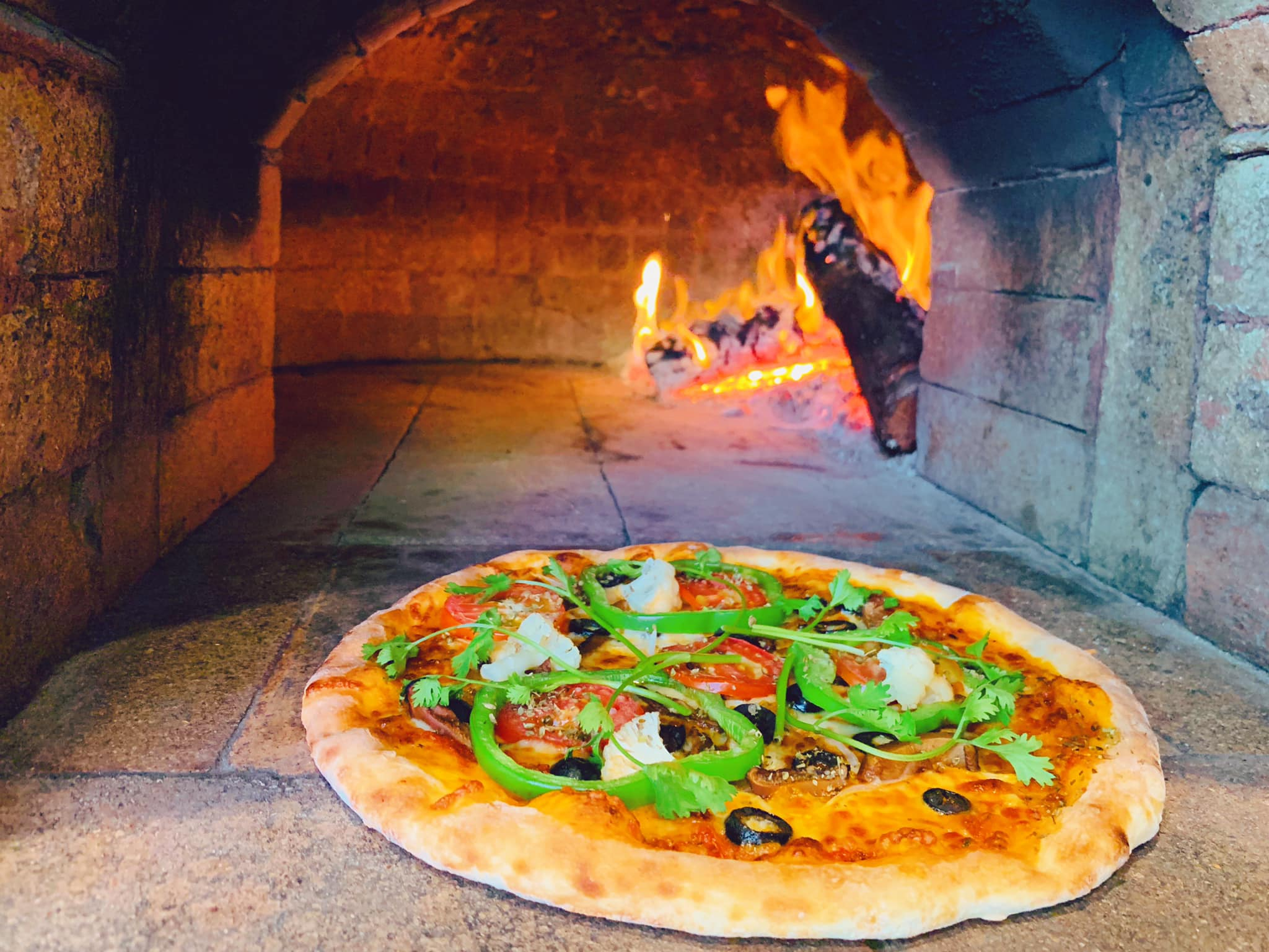Their wood-fired pizzas come with a thin, crispy base and generous layers of fresh ingredients 